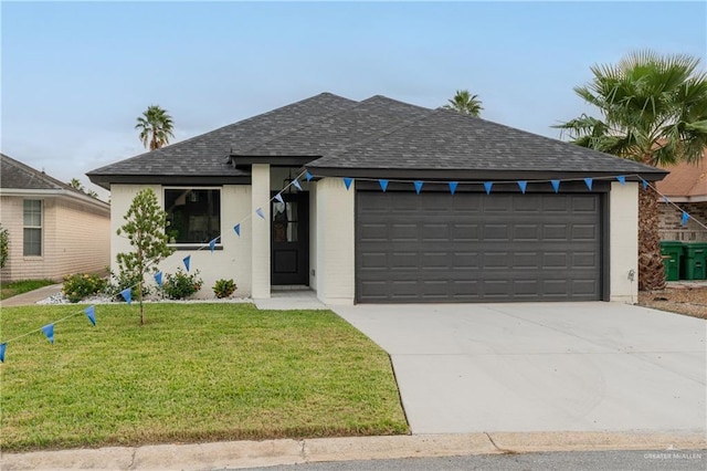 view of front of property featuring a garage and a front lawn