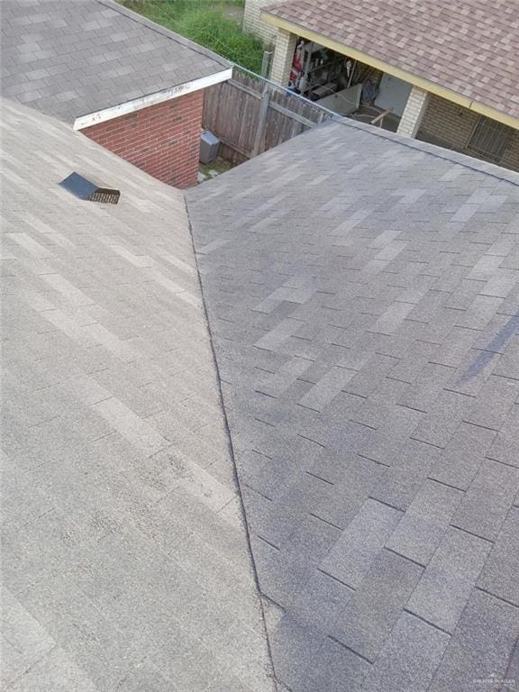 details with a shingled roof and fence