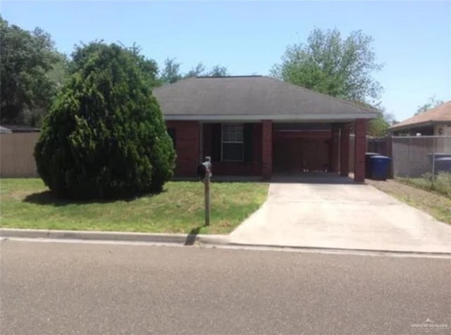 single story home featuring driveway, a front lawn, and fence