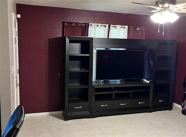 living room with a textured wall and ceiling fan