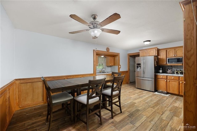 dining area with ceiling fan and light wood-type flooring