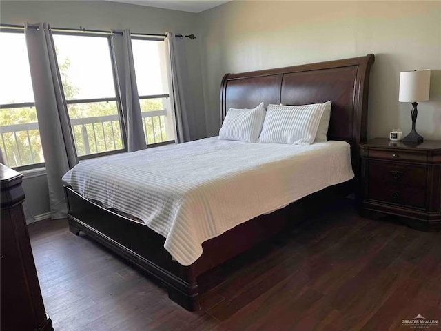 bedroom with dark wood-type flooring