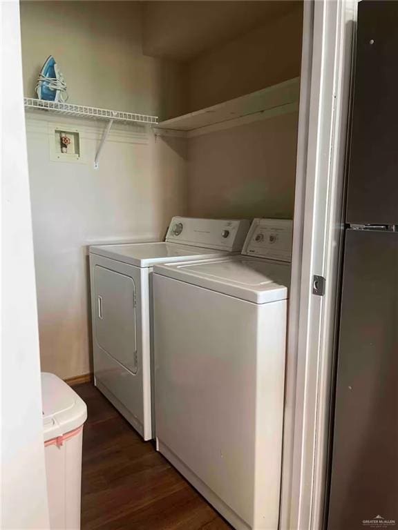 laundry area featuring dark hardwood / wood-style floors and washing machine and clothes dryer