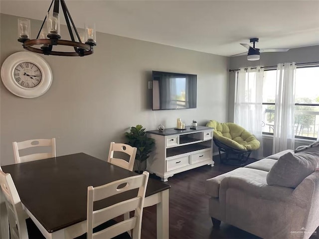 living room featuring ceiling fan and dark hardwood / wood-style flooring