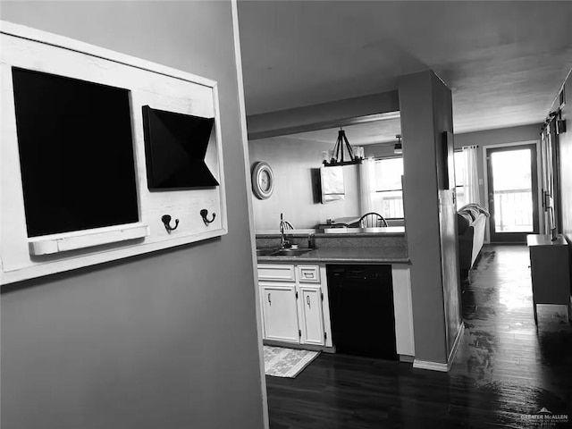 kitchen featuring dark hardwood / wood-style flooring, sink, dishwasher, and white cabinets