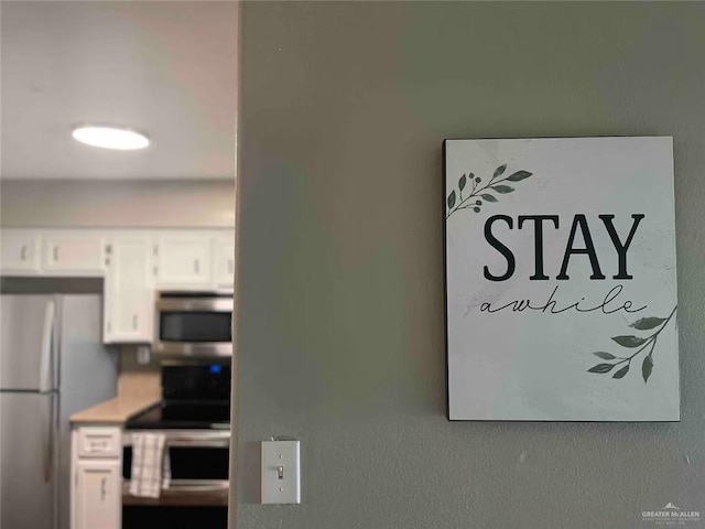 details with stainless steel appliances and white cabinetry