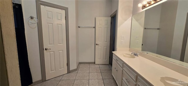 1706 Primrose Ave, Mission, TX 78572 - bathroom featuring tile patterned floors, double vanity, and baseboards
