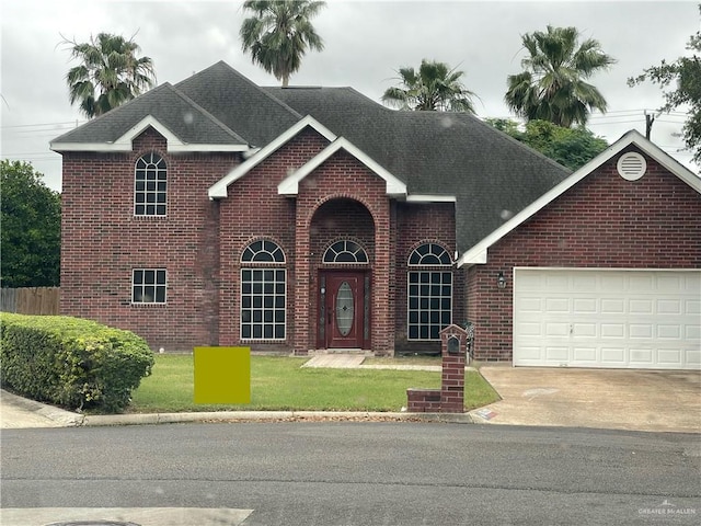 1706 Primrose Ave, Mission, TX 78572 - traditional-style house with brick siding, an attached garage, concrete driveway, and roof with shingles