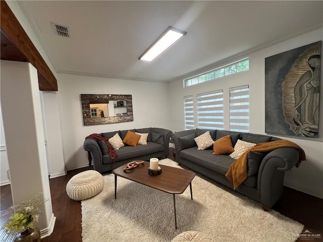 living room featuring baseboards, wood finished floors, visible vents, and crown molding
