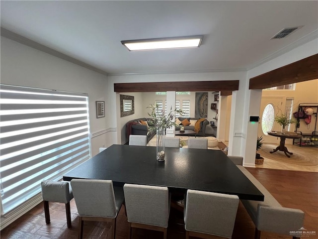 dining area featuring visible vents and crown molding