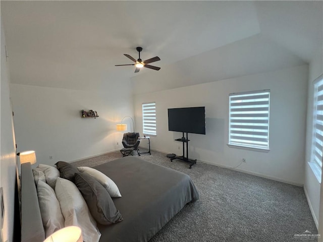 carpeted bedroom featuring vaulted ceiling, a ceiling fan, and baseboards