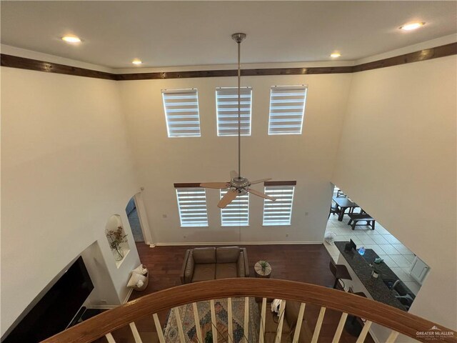foyer entrance with baseboards, a ceiling fan, a towering ceiling, and recessed lighting