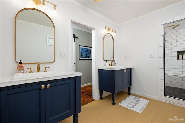 902 N 15th St, Mcallen, TX 78501 - full bathroom featuring two vanities, tiled shower, crown molding, and wood finished floors