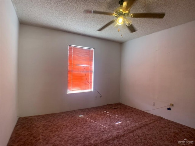 carpeted spare room with ceiling fan and a textured ceiling