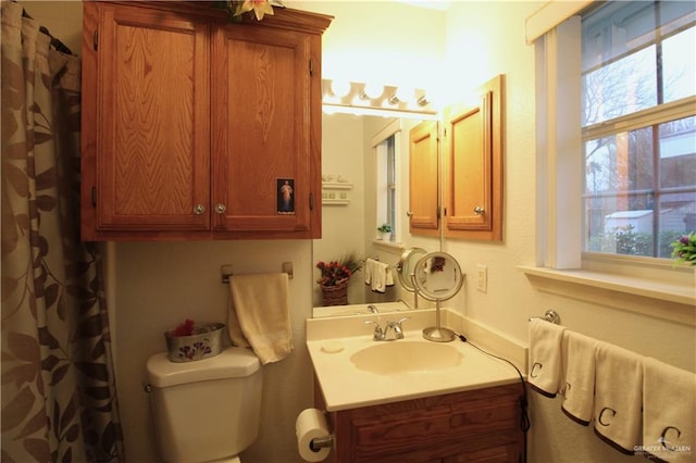 bathroom featuring toilet and vanity