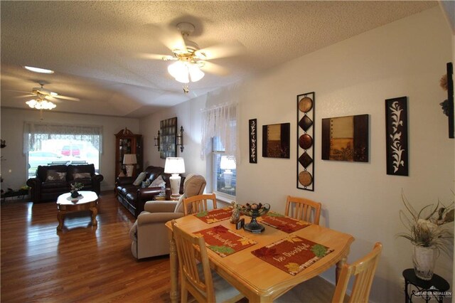 dining space with ceiling fan, a textured ceiling, and hardwood / wood-style floors