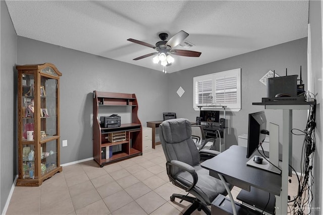 tiled home office with a textured ceiling and ceiling fan