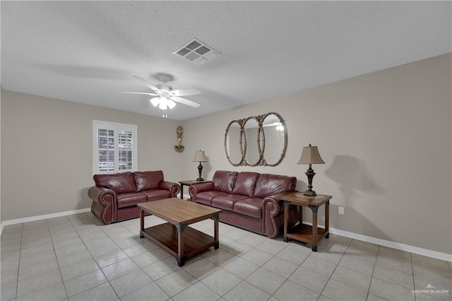 tiled living room featuring ceiling fan and a textured ceiling