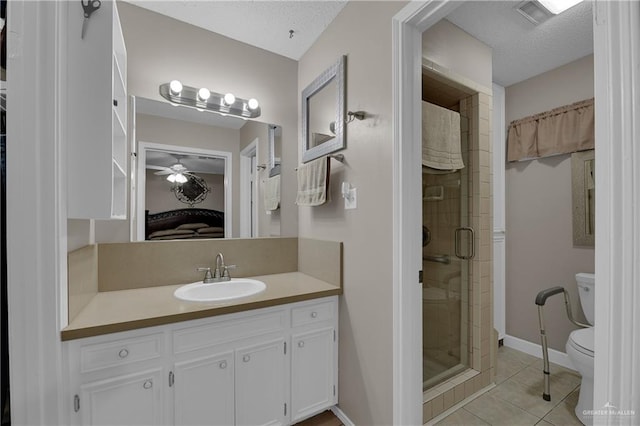 bathroom with tile patterned flooring, toilet, an enclosed shower, and a textured ceiling