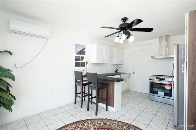 kitchen with a wall mounted air conditioner, appliances with stainless steel finishes, a kitchen breakfast bar, wall chimney exhaust hood, and white cabinetry