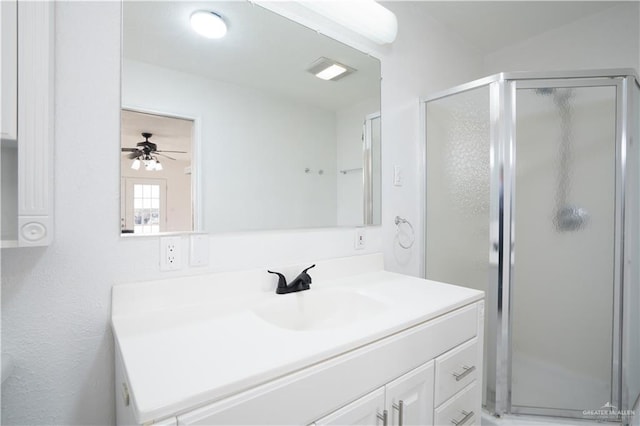 bathroom with vanity, walk in shower, and ceiling fan