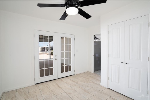 empty room with ceiling fan and french doors