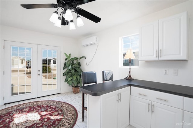 tiled office space featuring french doors, a wall mounted AC, and ceiling fan