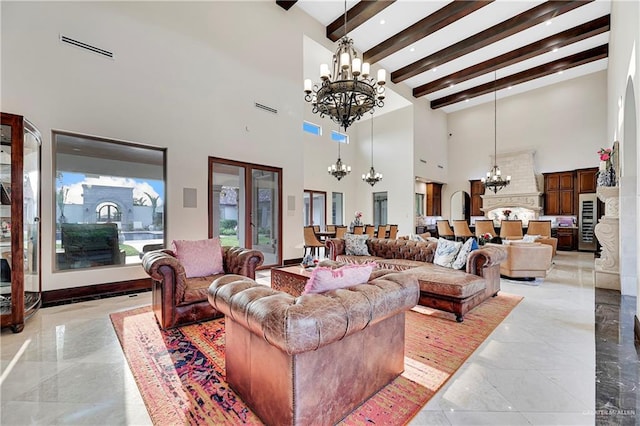 living room with beam ceiling, a towering ceiling, and a notable chandelier