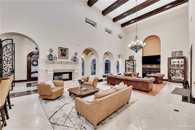 living room featuring beam ceiling, high vaulted ceiling, and a notable chandelier