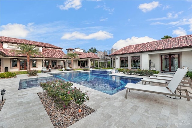 view of swimming pool with an in ground hot tub, pool water feature, and a patio area