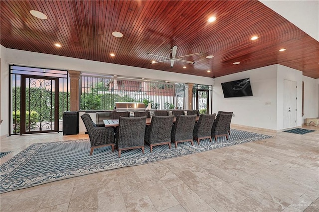 dining space featuring ceiling fan and wooden ceiling