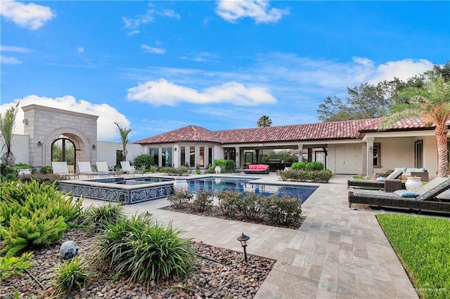 view of swimming pool featuring an in ground hot tub and a patio