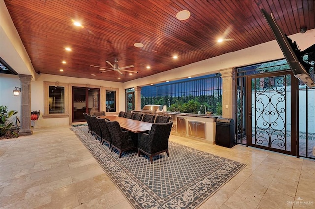 dining room with decorative columns, ceiling fan, and wood ceiling