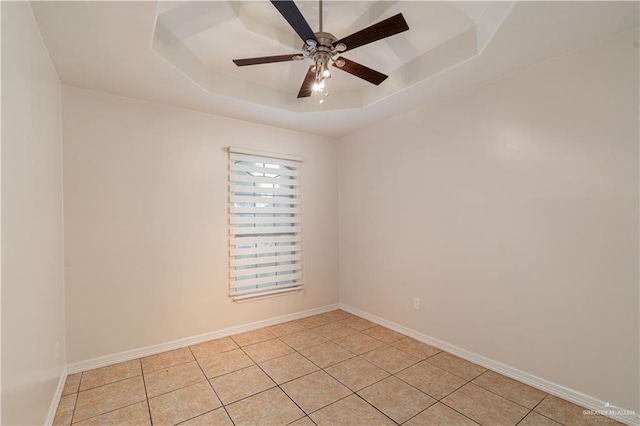 1711 Esperanza Ave, Hidalgo, TX 78557 - empty room featuring a raised ceiling, light tile patterned flooring, and a ceiling fan