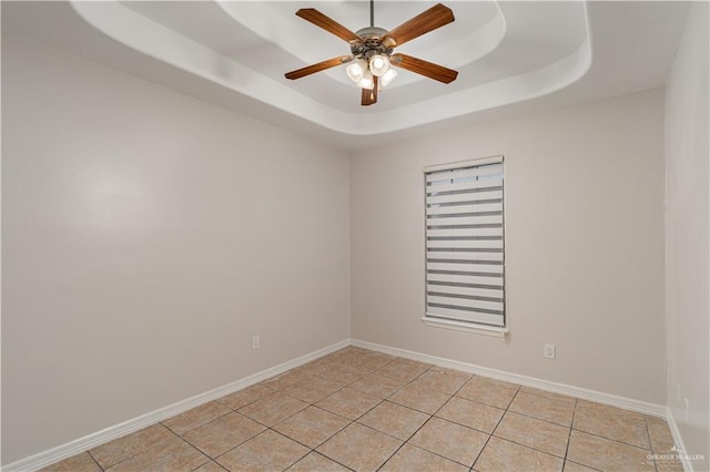 1711 Esperanza Ave, Hidalgo, TX 78557 - unfurnished room featuring a ceiling fan, a raised ceiling, and light tile patterned floors