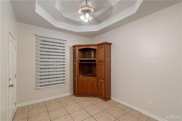 1711 Esperanza Ave, Hidalgo, TX 78557 - spare room with light tile patterned flooring, ceiling fan, and a tray ceiling