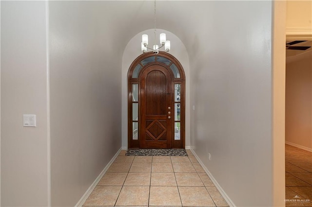 1711 Esperanza Ave, Hidalgo, TX 78557 - doorway to outside with arched walkways, light tile patterned flooring, and a chandelier