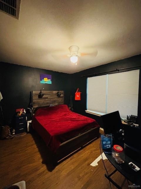 bedroom with hardwood / wood-style floors and ceiling fan