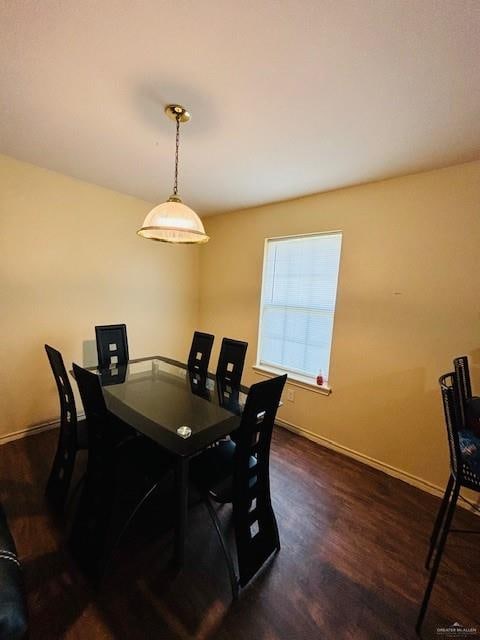 dining space with dark hardwood / wood-style flooring