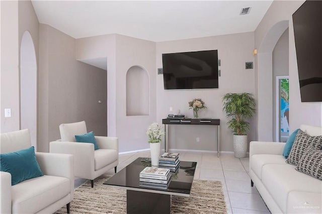 3004 San Federico Rd, Mission, TX 78572 - living room with light tile patterned flooring, arched walkways, visible vents, and baseboards