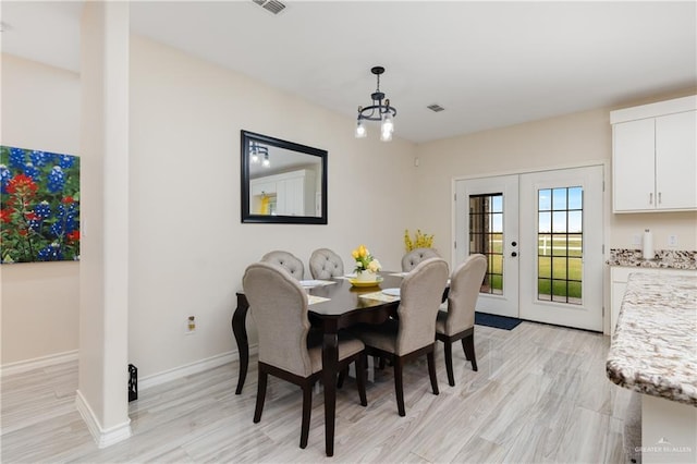 dining area with french doors and light wood-type flooring