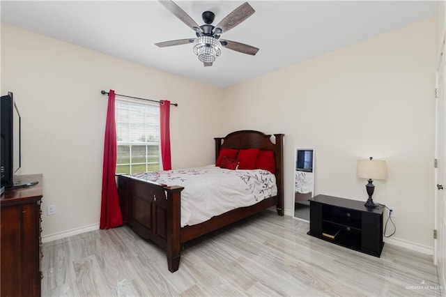 bedroom with ceiling fan and light hardwood / wood-style floors