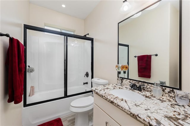 full bathroom with toilet, vanity, bath / shower combo with glass door, and hardwood / wood-style floors