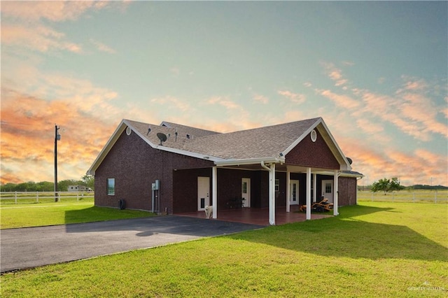 view of front of home featuring a yard and a patio area