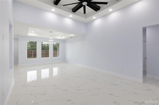 1232 Bridle Way, San Benito, TX 78586 - unfurnished room with recessed lighting, a tray ceiling, a ceiling fan, baseboards, and light marble finish floors