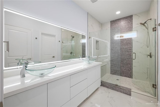 1232 Bridle Way, San Benito, TX 78586 - bathroom featuring a marble finish shower, double vanity, marble finish flooring, and recessed lighting