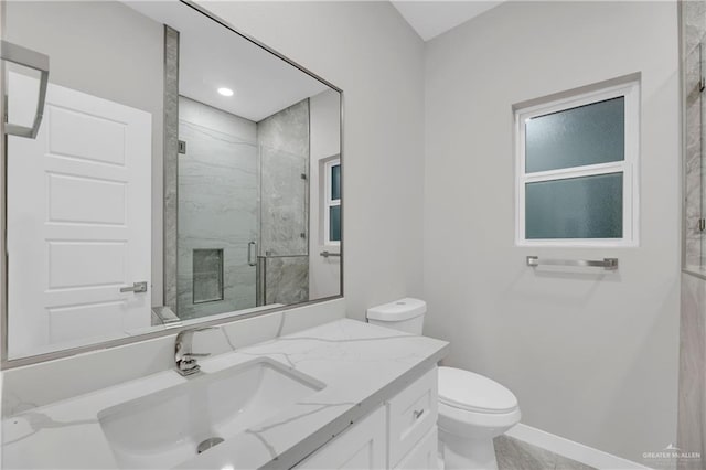 bathroom with vanity, toilet, and a shower with door