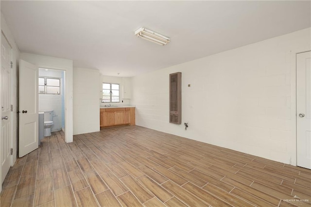 816 E 12th St, Mission, TX 78572 - empty room with light wood finished floors and a heating unit