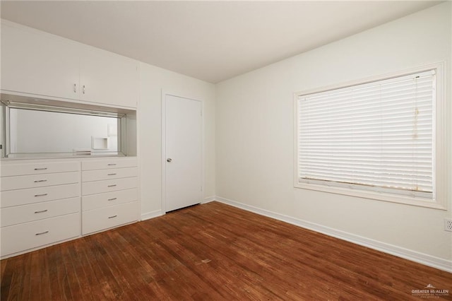 816 E 12th St, Mission, TX 78572 - unfurnished bedroom with dark wood-style flooring and baseboards
