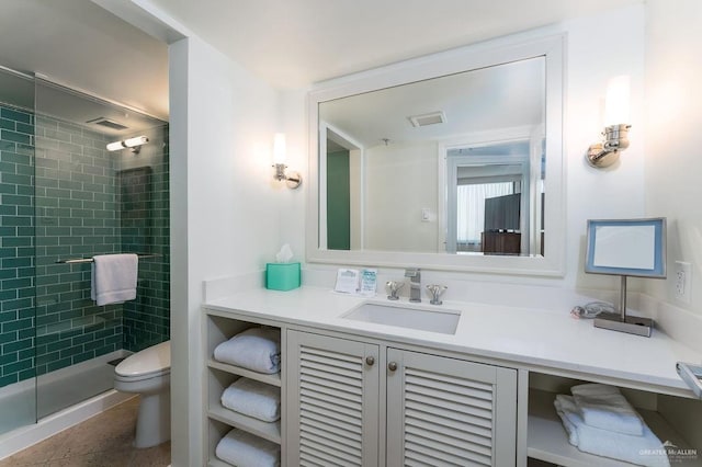 bathroom with vanity, visible vents, toilet, and a shower stall